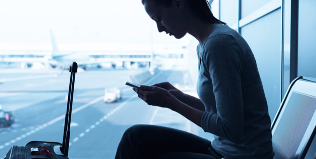 woman looking at phone at airport