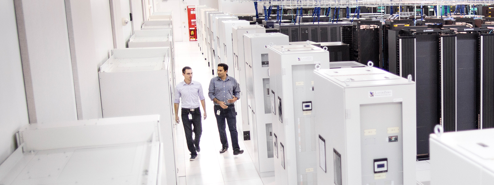 two men walking through a data center