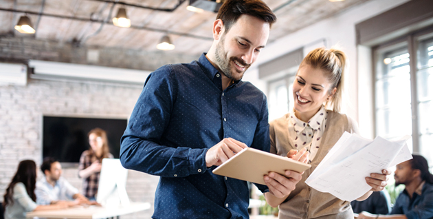 man and woman working in their office