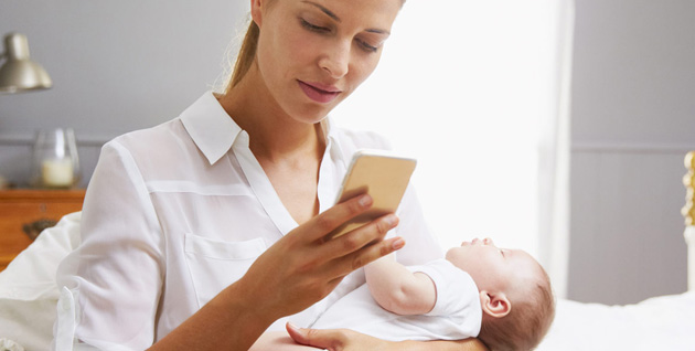 Woman on phone holding a baby