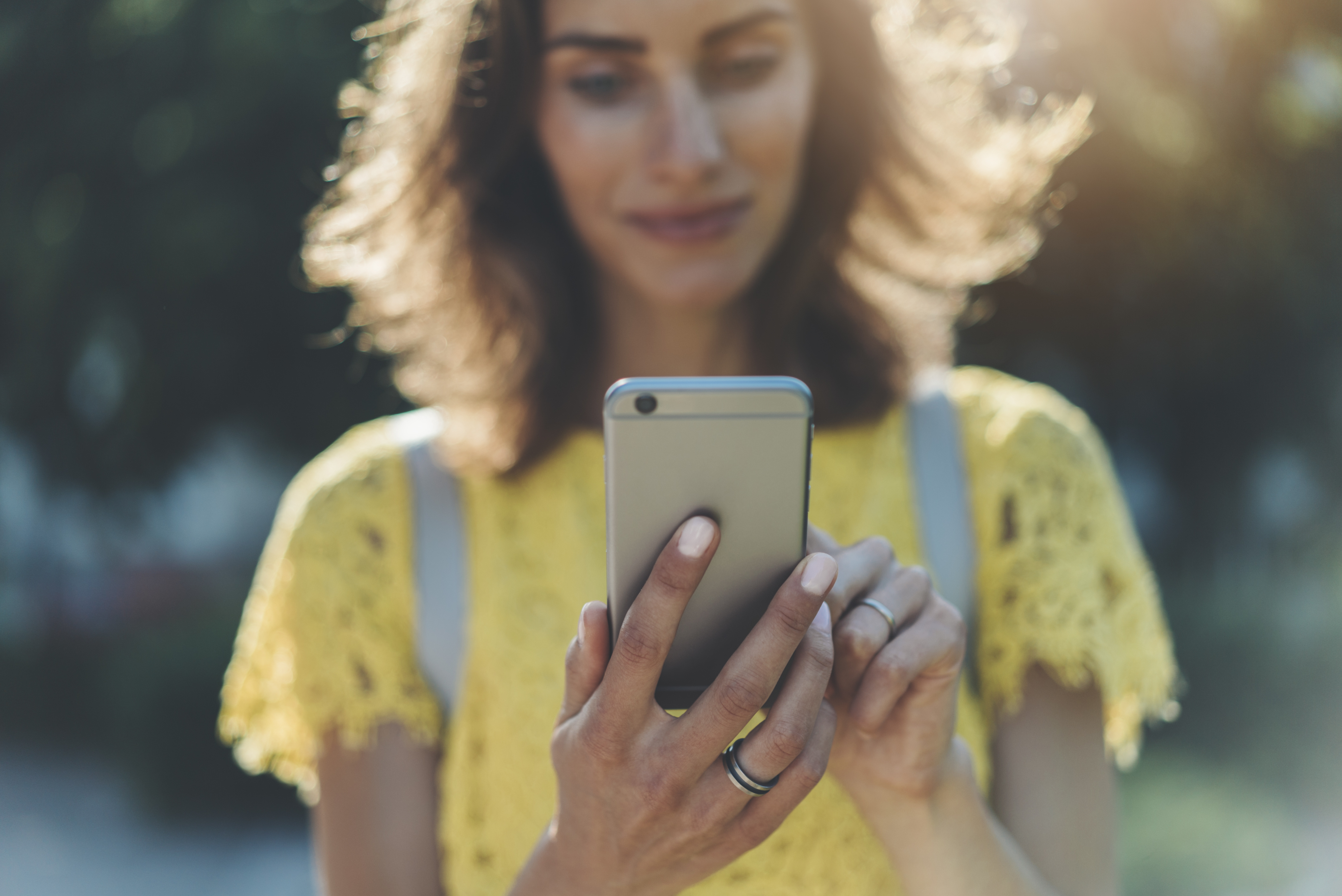 Women holding mobile ph and smiling