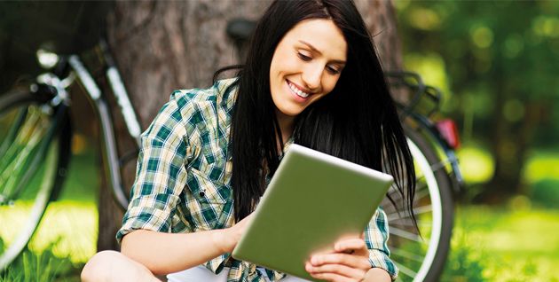 Woman outside looking at a tablet